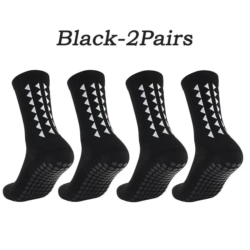 A set of five black athletic grip socks displayed individually.