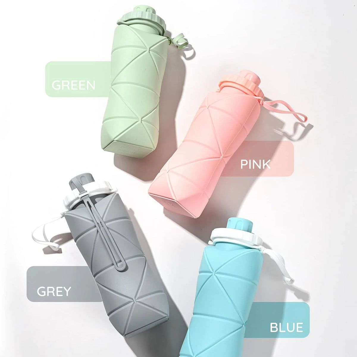 A collection of five collapsible silicone sports water bottles in green, pink, grey, and blue, shown against a white backgrou