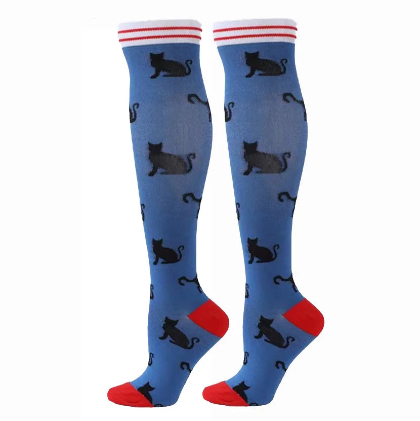 Pair of blue compression elastic socks featuring a repeating black cat pattern and red trim.