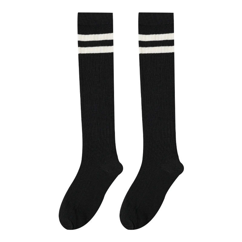 Black cotton knee high socks with white stripes on the leg