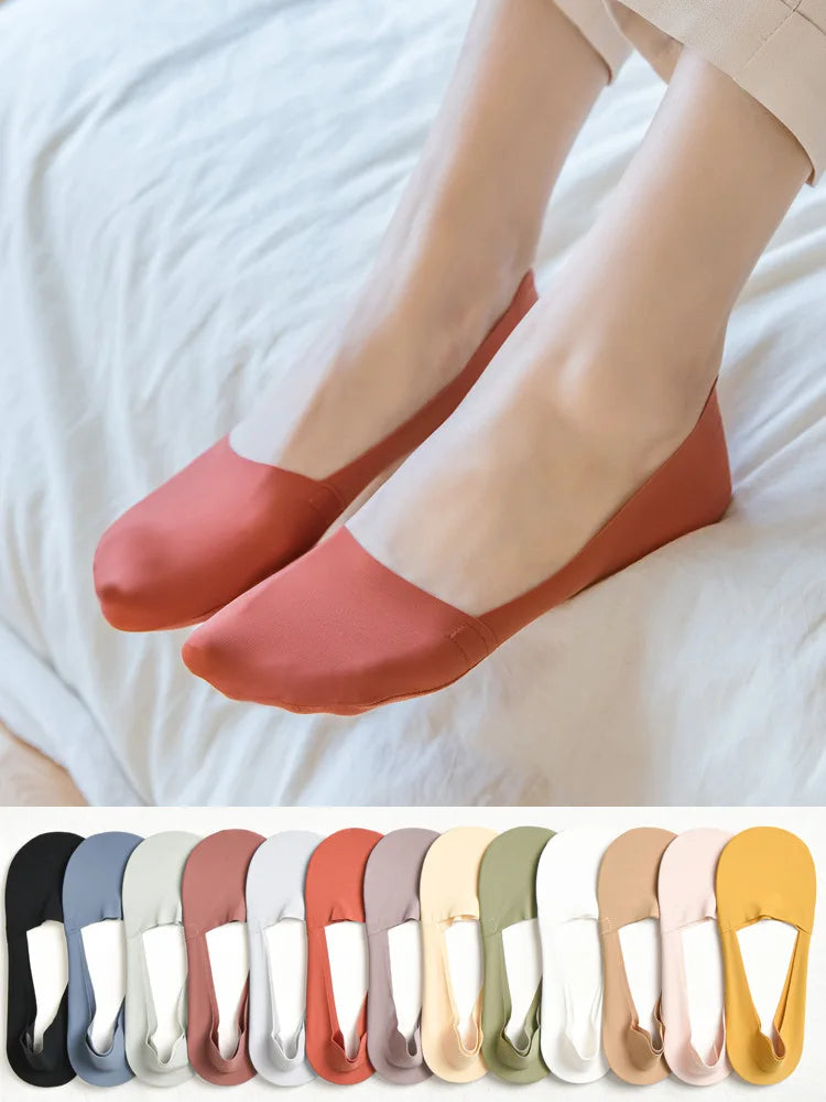 A pair of terracotta silicone anti-slip summer socks worn on a person's feet against a white background.