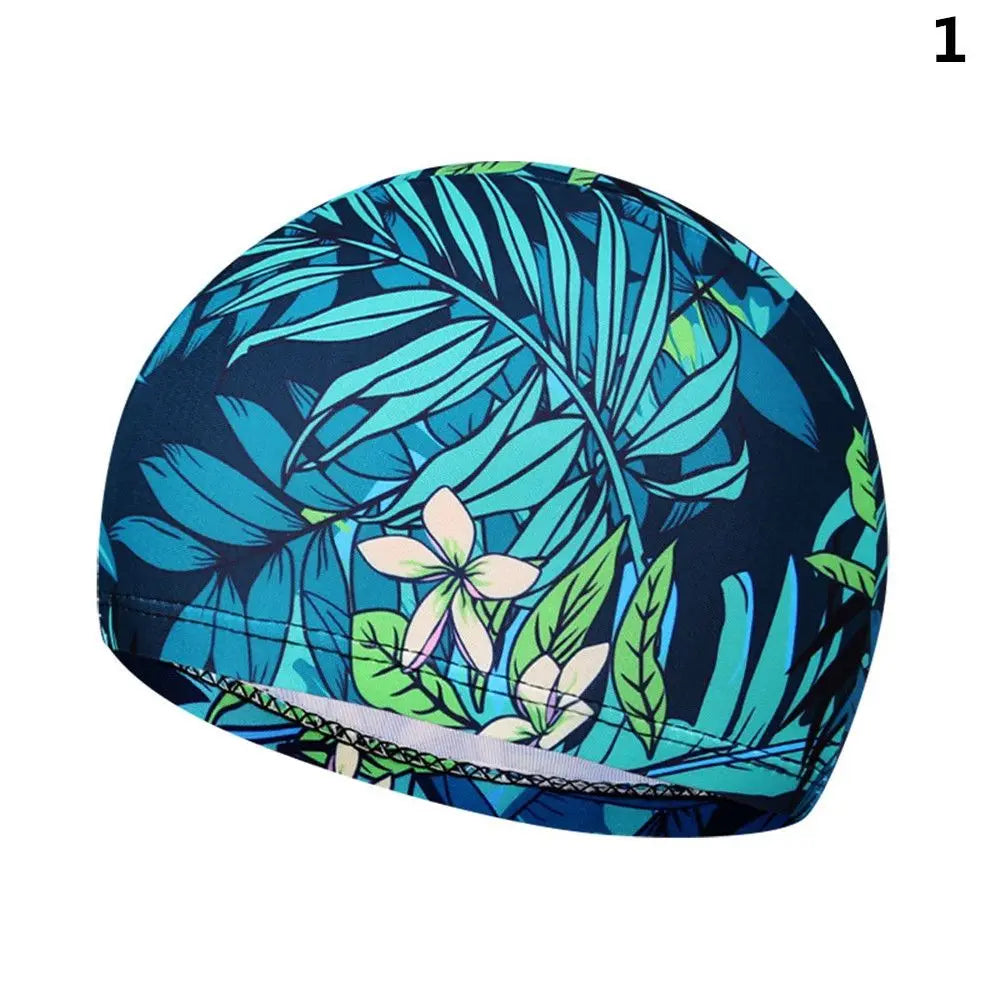 Bonnet de bain en nylon élastique bleu foncé et sarcelle à motifs de feuilles tropicales.