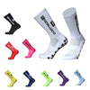 A collection of black, pink, white, and various colored anti-slip silicone grip football socks displayed in different angles.