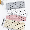 A set of four polka dot elastic hair bands in gray, white, and pink tones displayed on a white background.
