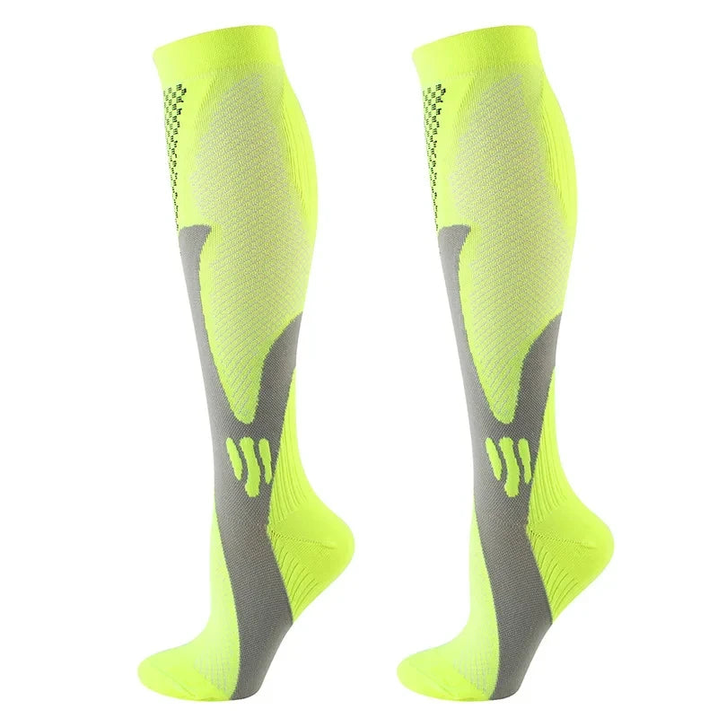 A pair of neon yellow compression socks with a gray anatomical design.
