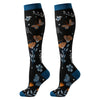 Pair of knee-high compression socks featuring a black background with floral and butterfly patterns and blue trim.