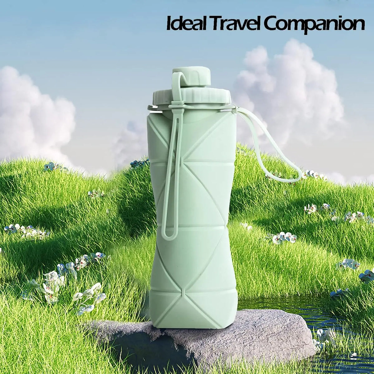 A light green collapsible silicone sports water bottle standing on a rock in a grassy outdoor setting.