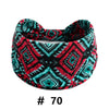 A patterned fabric turban headband featuring black, red, and teal geometric designs.