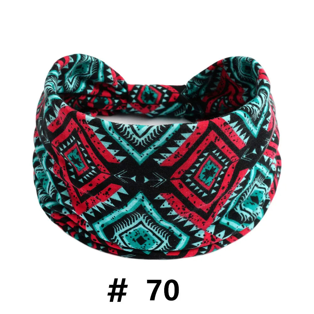 A patterned fabric turban headband featuring black, red, and teal geometric designs.