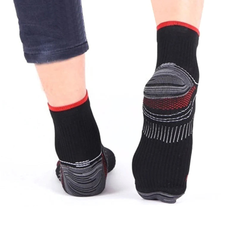 Black compression socks with red trim and gray arch support for foot comfort