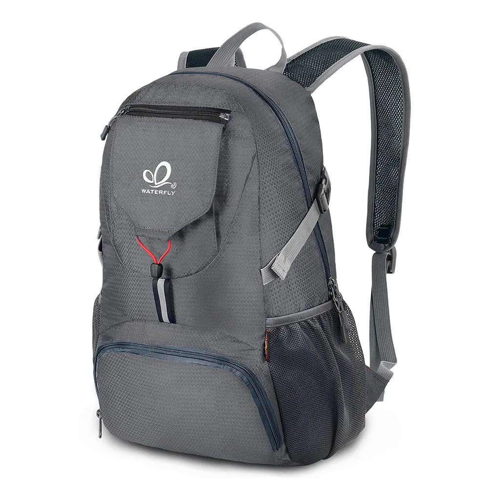 A gray ultra-light foldable travel backpack with multiple compartments and straps.