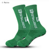 A pair of green football socks with white text are displayed on a white background.