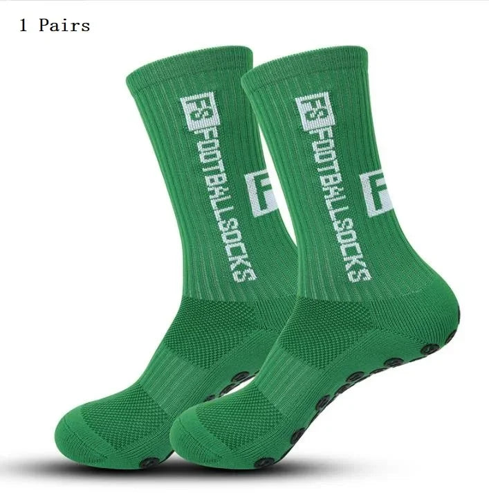 A pair of green football socks with white text are displayed on a white background.