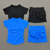 A set of black and bright blue seamless yoga workout clothing including a short sleeve top and shorts.