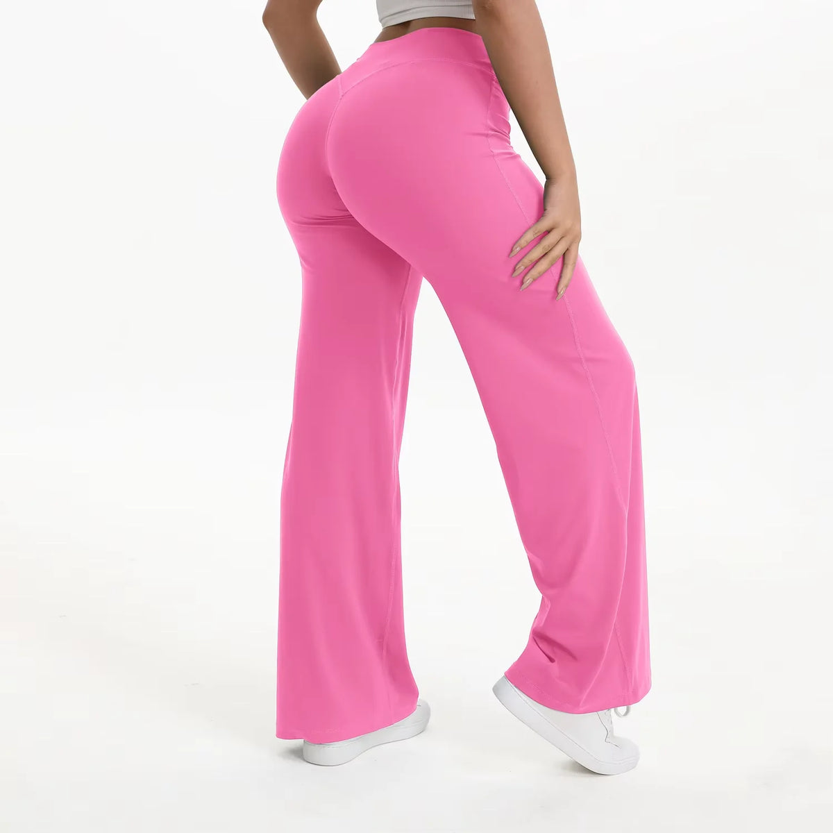A woman wearing bright pink NCLAGEN SoftMotion straight leg yoga pants