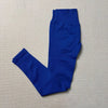 A royal blue pair of high-waisted seamless yoga leggings laid flat on a light beige surface.