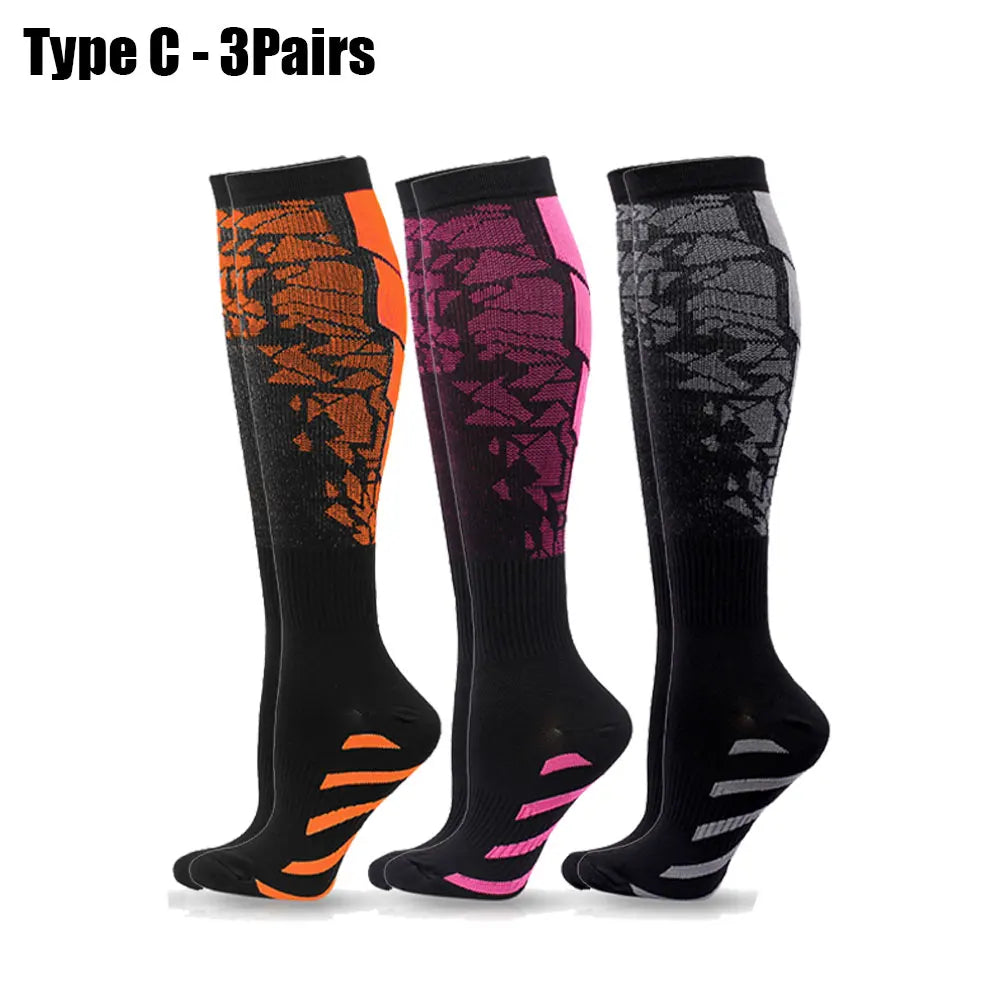 Three pairs of Type C compression socks in black, orange, and purple for sports or daily use.