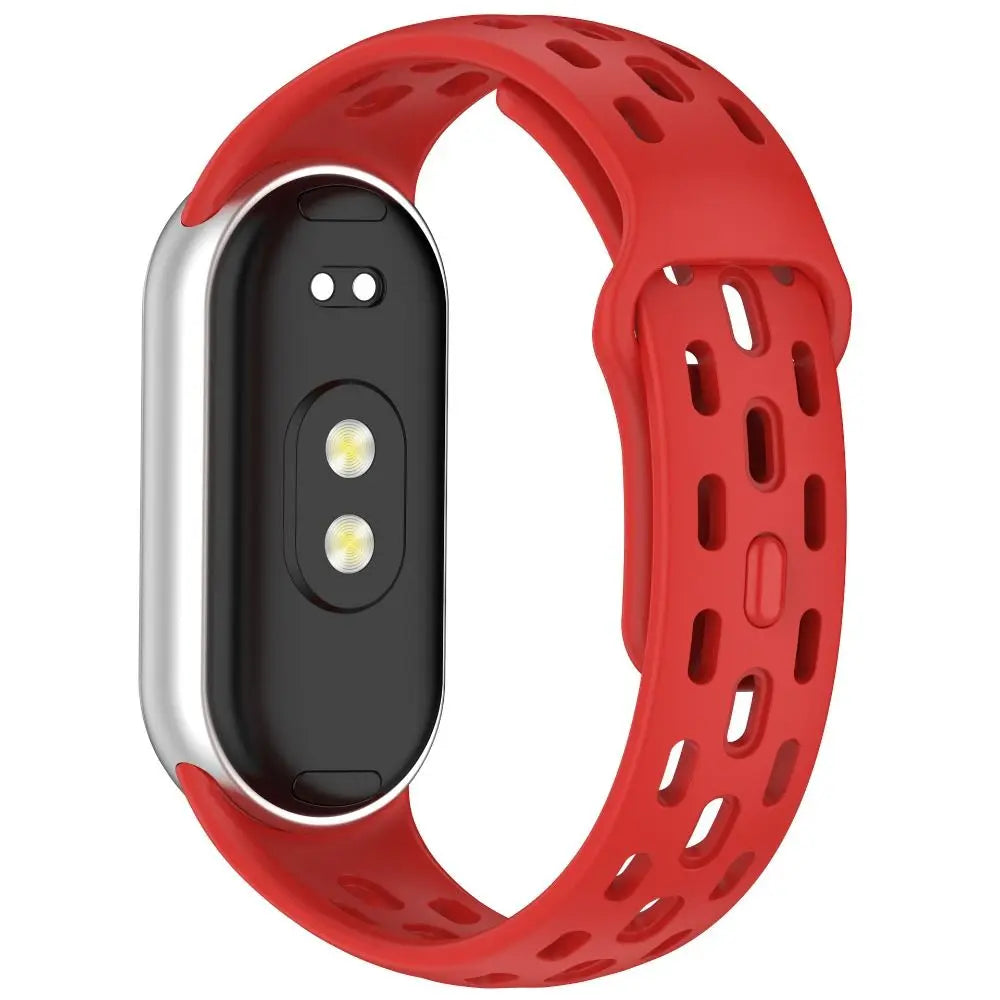 A red silicone smart watch band replacement with a black casing and multiple holes for breathability.