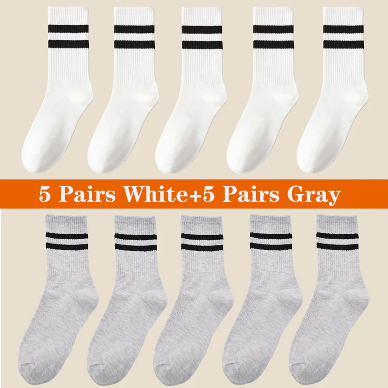 A collection of 10 pairs of white and gray athletic socks displayed in various styles.