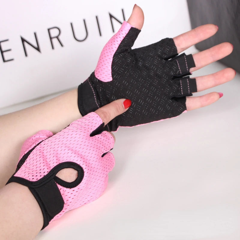 A hand wearing a pink fingerless gym glove and a black anti-slip glove, displayed against a white background.