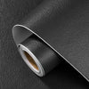 Roll of black self-adhesive leather repair patches on a dark surface.