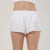 White women's high-waisted running shorts displayed on a model.