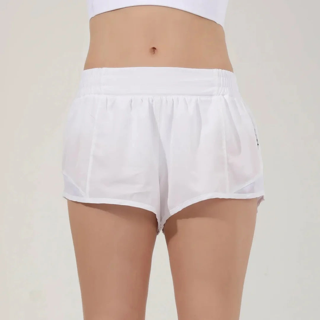 White women's high-waisted running shorts displayed on a model.