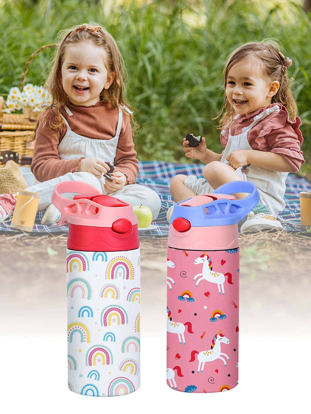 Two young girls smiling while holding colorful cartoon pattern insulated stainless steel thermos cups.