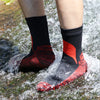 A pair of red and black waterproof breathable hiking socks worn by a person outdoors.