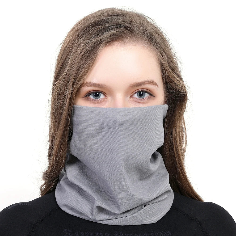 A young woman wearing a gray seamless fabric balaclava or neck gaiter.