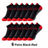 Six pairs of black and red knit sports socks laid out for display.