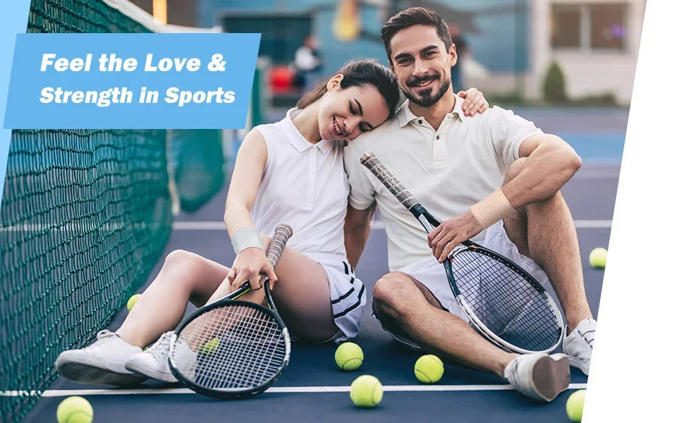 A smiling couple playing tennis on a court with tennis rackets and balls.