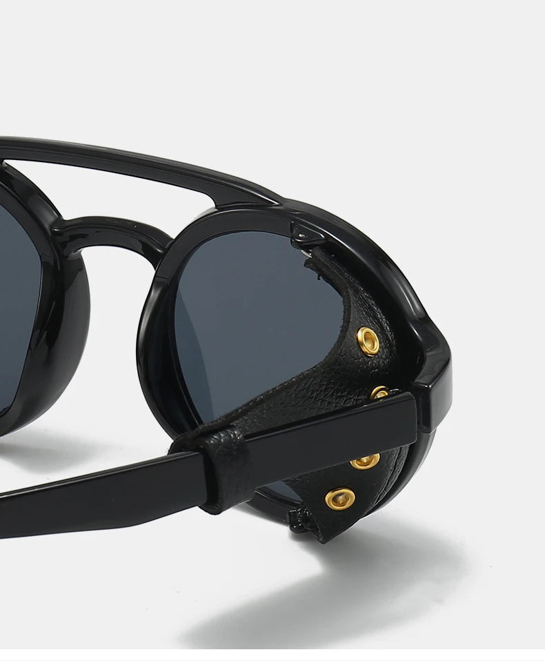 Black retro steampunk goggles sunglasses with gold accents shown in a close-up view.