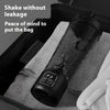 A black electric shaker bottle is placed in a gray fabric bag inside a dark container.