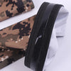 A pair of tactical camouflage arm sleeves shown folded, featuring brown and black patterns.