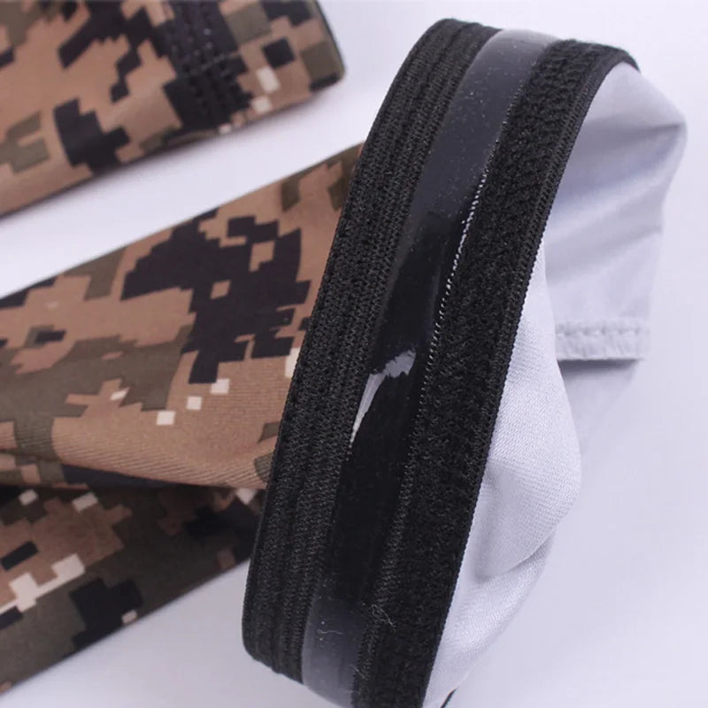 A pair of tactical camouflage arm sleeves shown folded, featuring brown and black patterns.