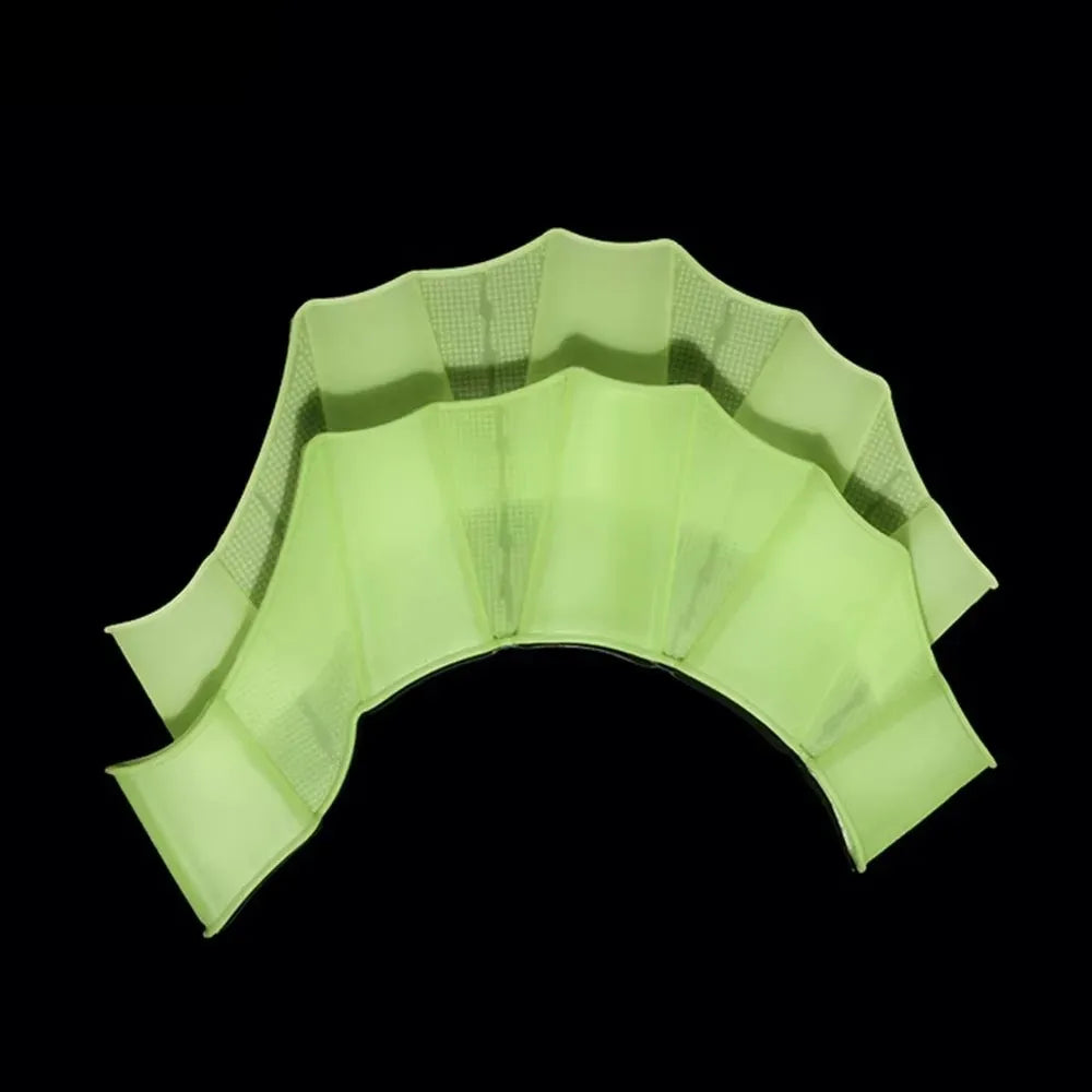 A set of lime green silicone swim training flippers displayed against a black background.