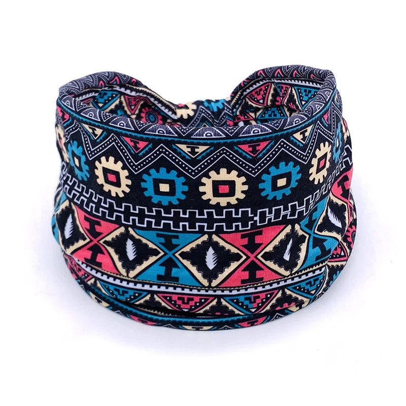 A colorful bohemian stretch cotton headband featuring geometric patterns in black, pink, and teal.