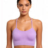 A model wearing a lilac ribbed crop top sports bra for yoga and fitness.