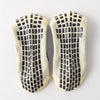 Pair of multi-sport silicone grip socks for men with a black and beige checkered pattern