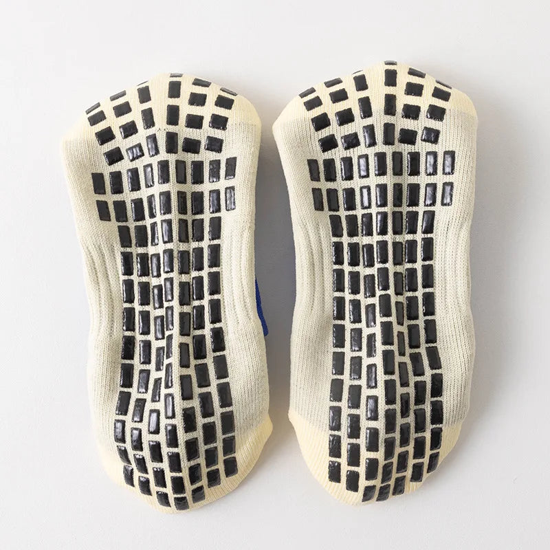 Pair of multi-sport silicone grip socks for men with a black and beige checkered pattern
