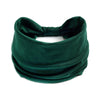 Un foulard en coton boho vert émeraude foncé noué en nœud.