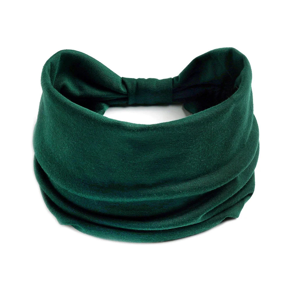 Un foulard en coton boho vert émeraude foncé noué en nœud.