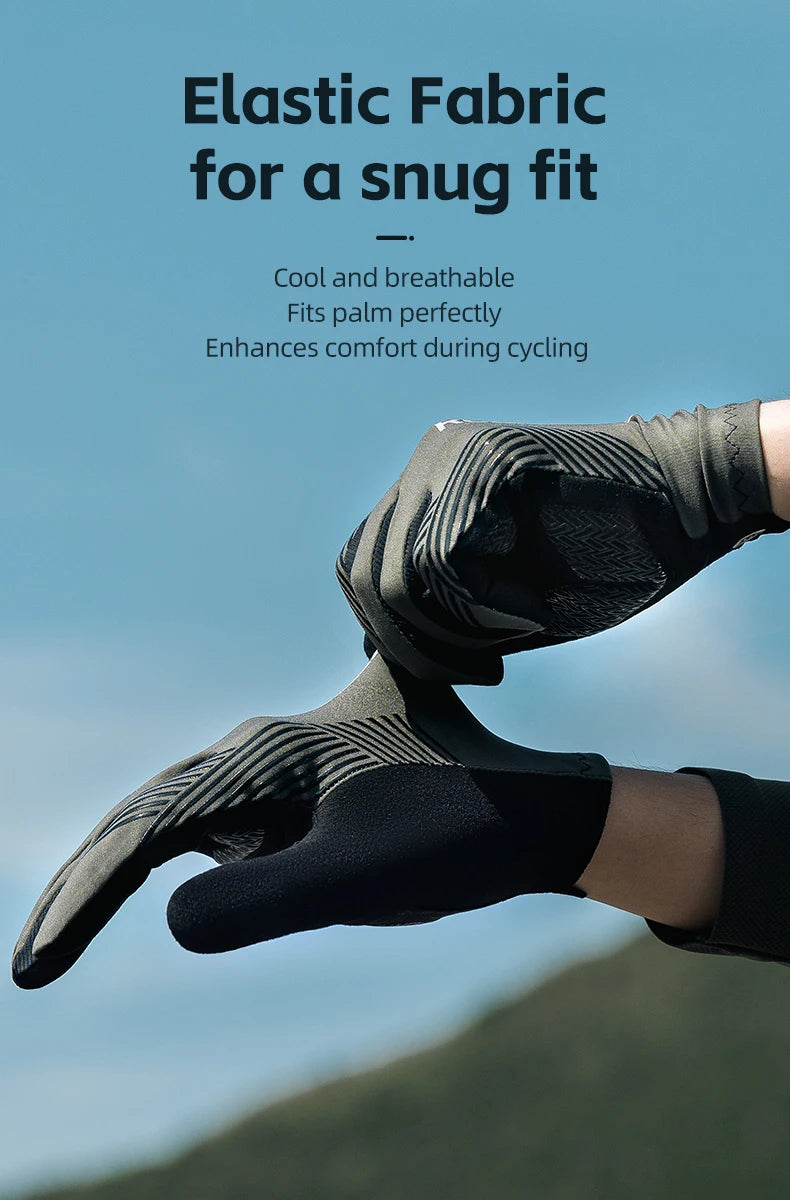 Close-up of black elastic fabric cycling gloves being worn outdoors against a blurred green landscape.