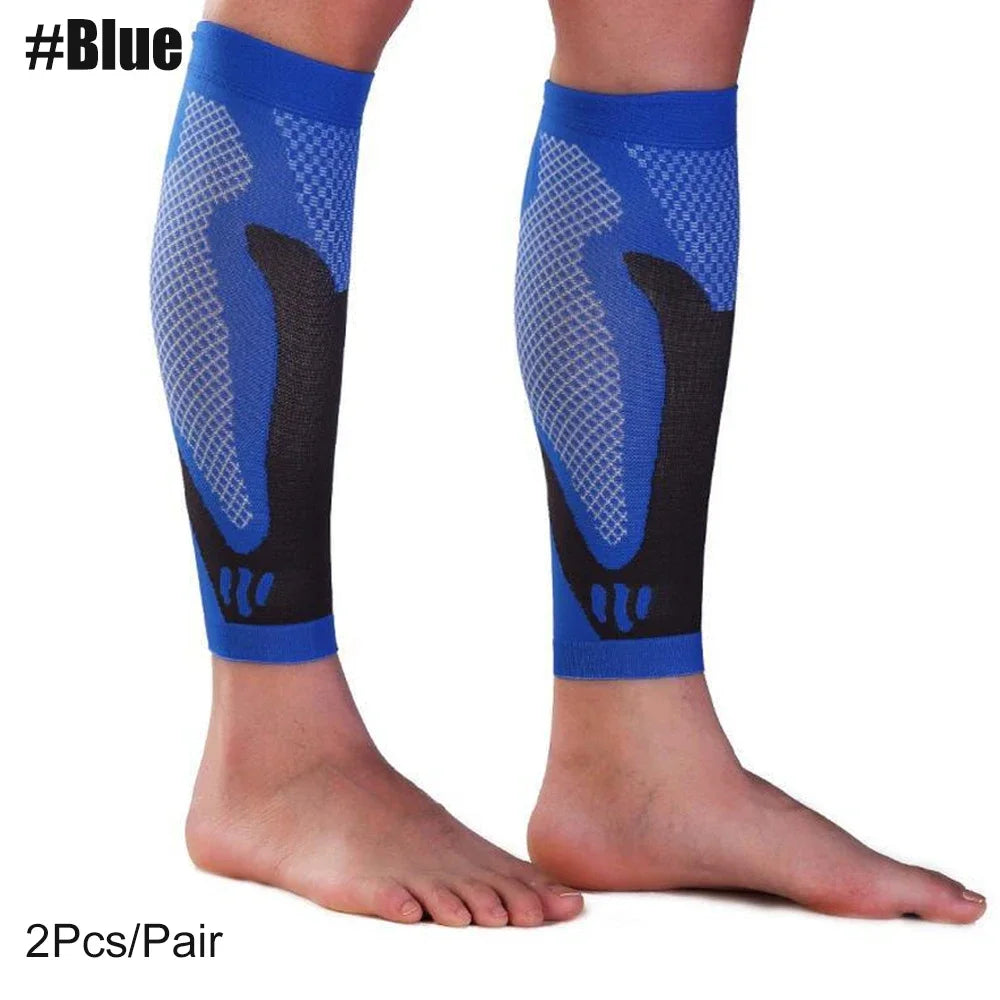 A pair of blue calf compression sleeves with black and blue mesh patterns shown on a person's legs.