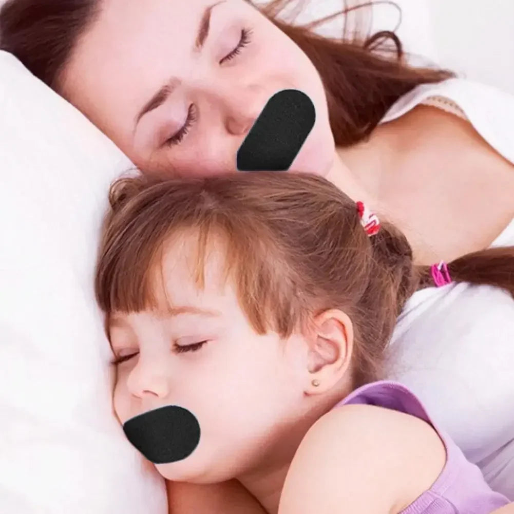 A young child is sleeping with a black anti-snoring nasal strip applied to her nose.
