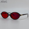 A pair of tortoiseshell-framed sunglasses with vibrant red lenses.