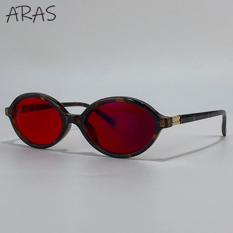 A pair of tortoiseshell-framed sunglasses with vibrant red lenses.