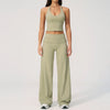 A woman wearing a light olive green women's premium fitness tracksuit top and matching pants.