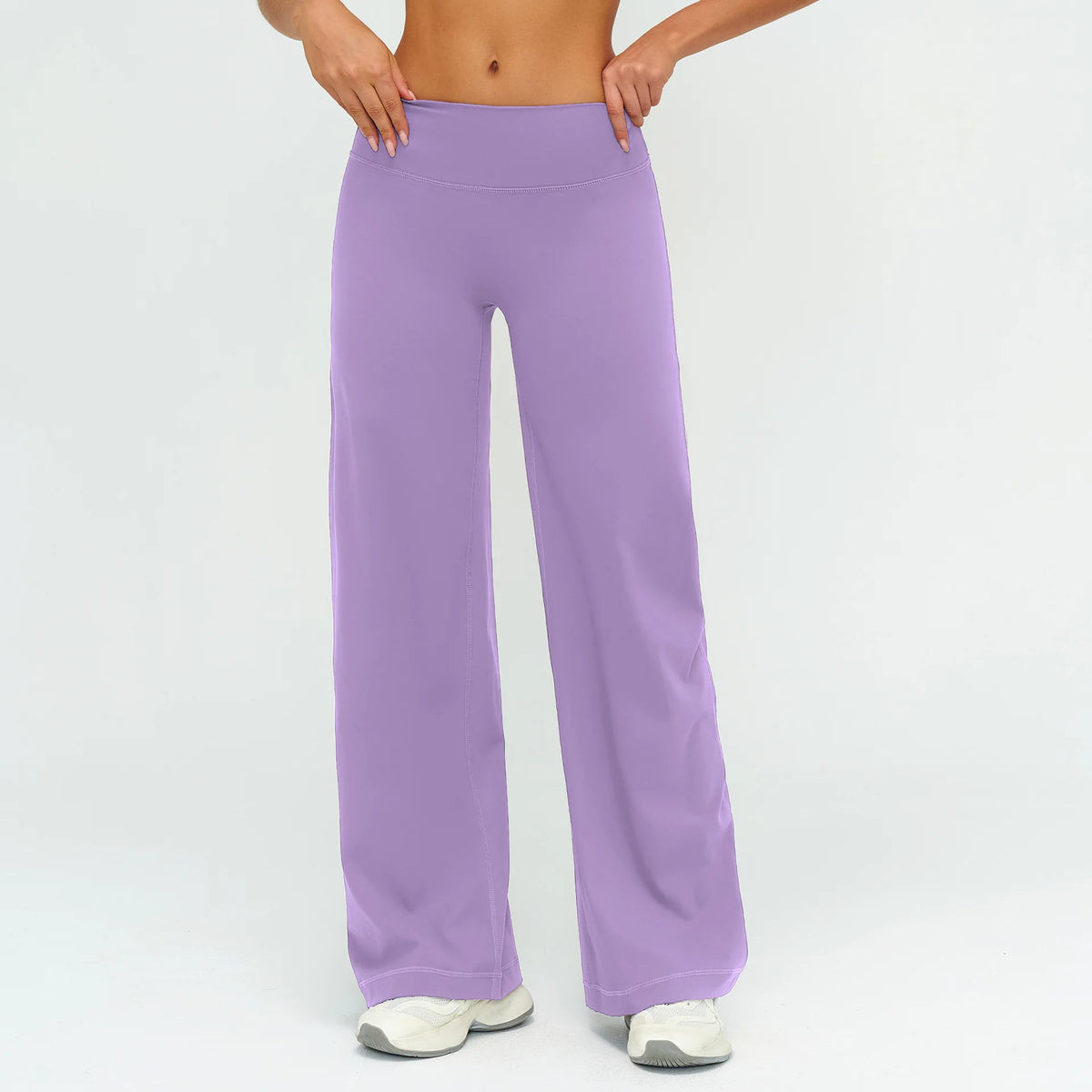 A woman is modeling purple high-waist flared yoga pants.